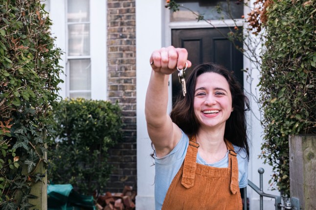 Happy woman showing new home keys