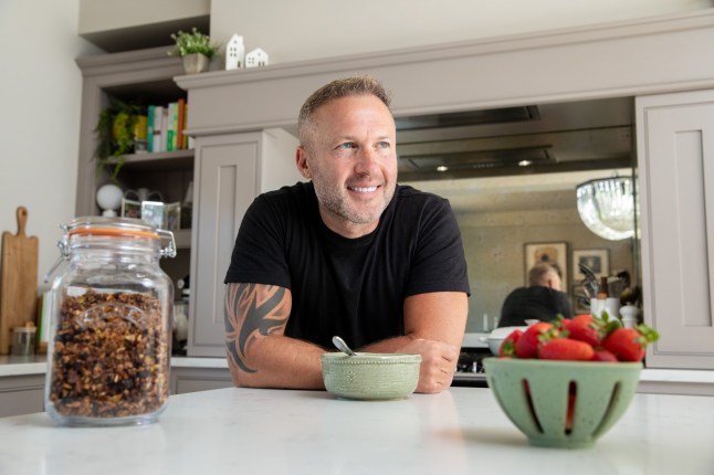 Metro - What's Cooking? Scott Harrison photographed at home with a jar of his quinoa granola for the What's Cooking column. 12th May 2025. PHOTOGRAPH BY DANIEL JONES 2025 +44 (0)7815 853503 info@danieljonesphotography.co.uk www.danieljonesphotography.co.uk